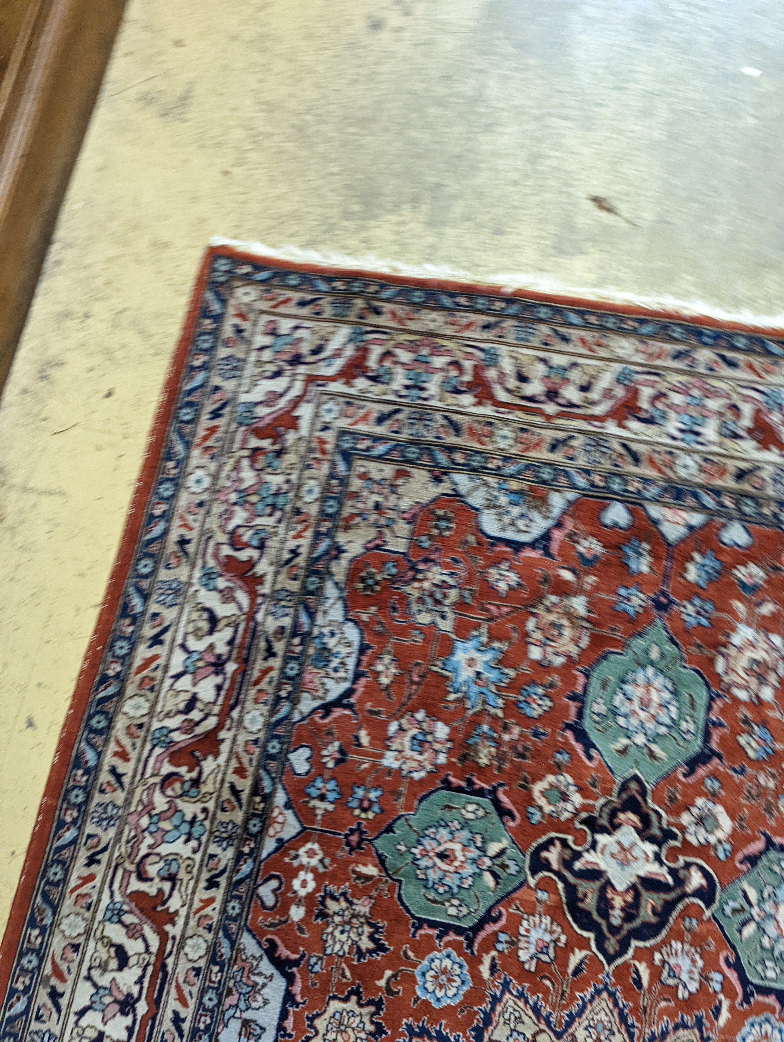 A Tabriz brick red ground rug, 230 x 138cm